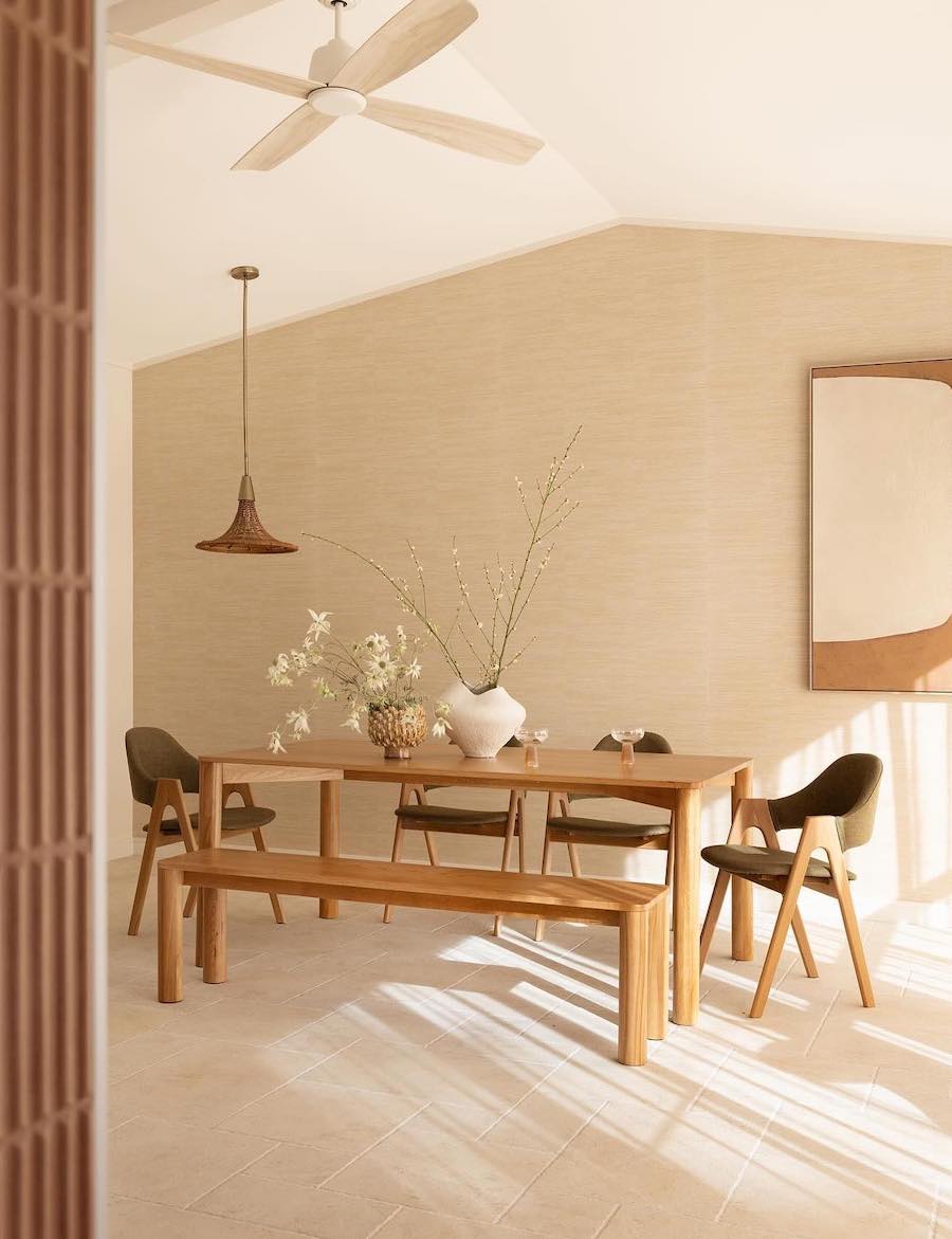 a dining room featuring warm browns and beiges and a minimalist design