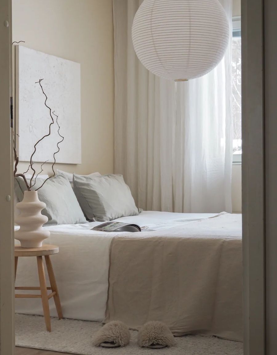 a bedroom with bright neutrals and japandi decor