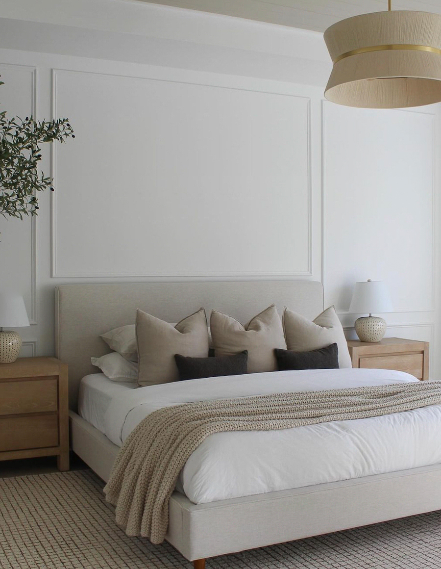 a minimalist bedroom featuring bright neutral shades and simple decor
