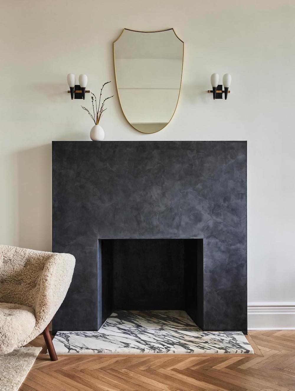 a grey plaster fireplace with modern and minimal decor
