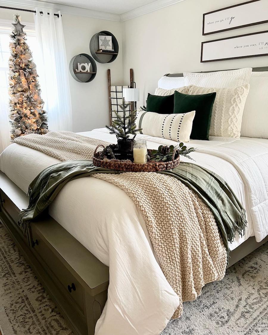 an elegant bedroom with ivory and green christmas decor