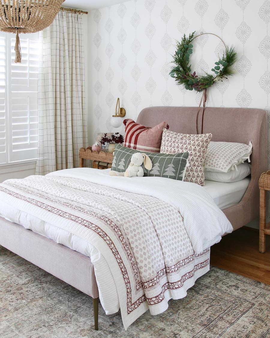 a bedroom with light tones and stylish holiday decor