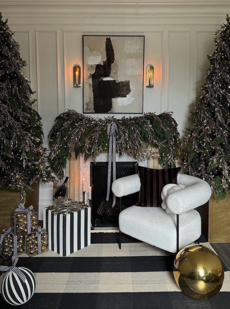 a christmas mantle with oversized pine garland, tinsel, and striped ribbons