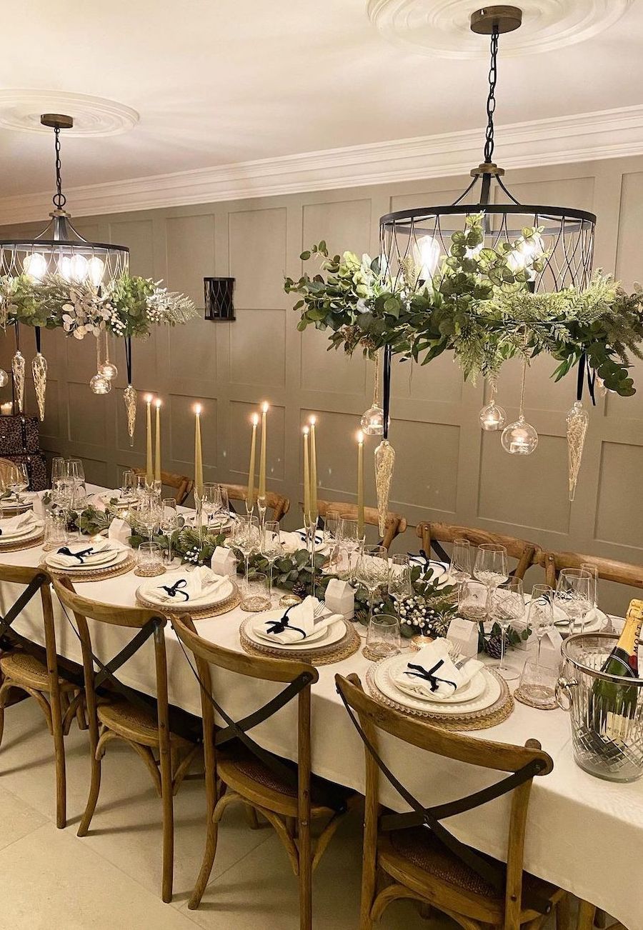 christmas table decorations featuring white and green tones with gold and clear ornament accents