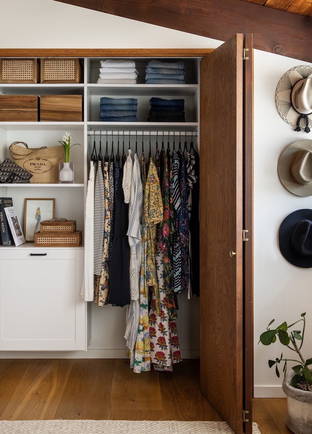 a closet with built in storage and a wood bifold door