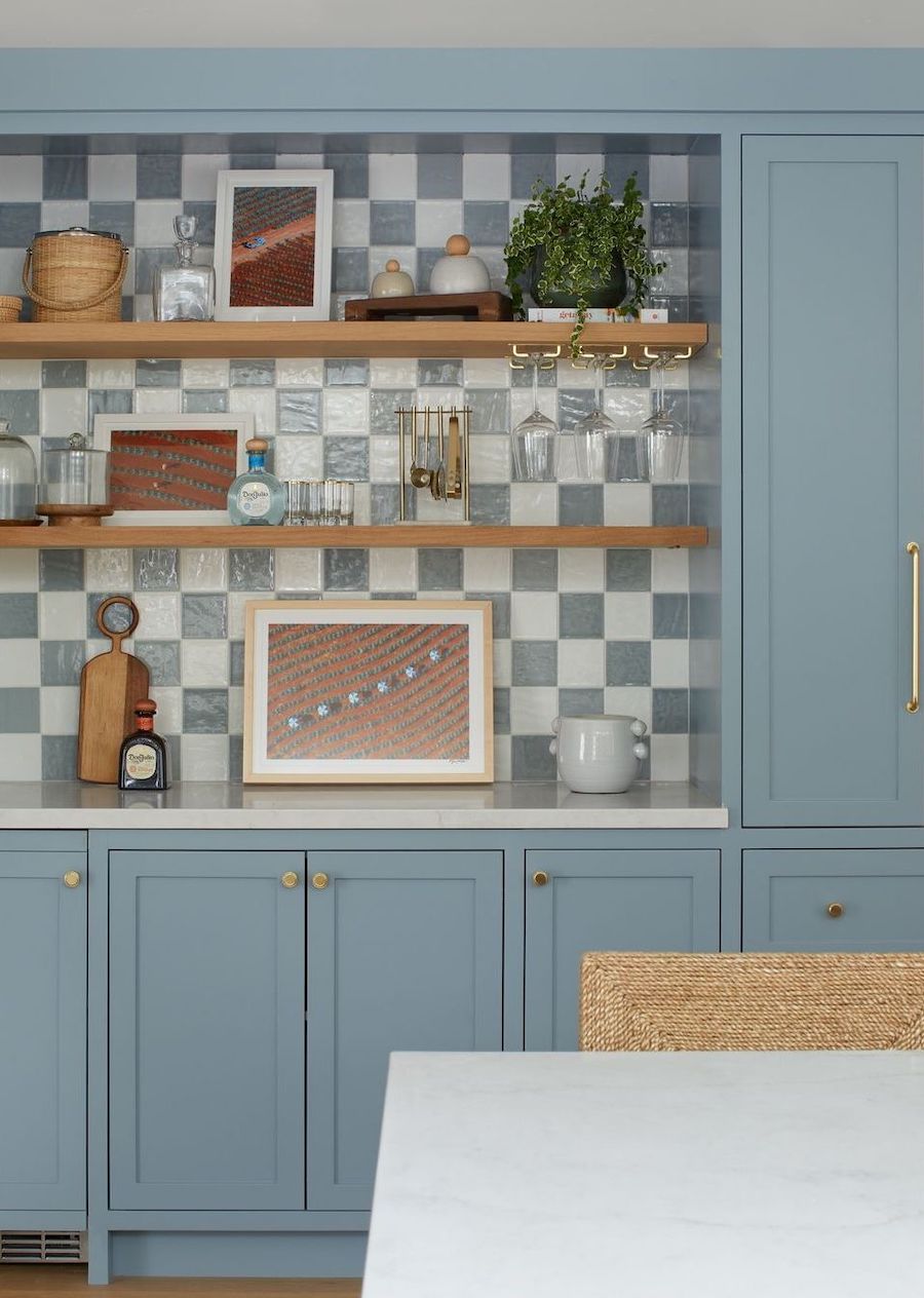 a coastal themed kitchen with blue and white tiles and beige accents
