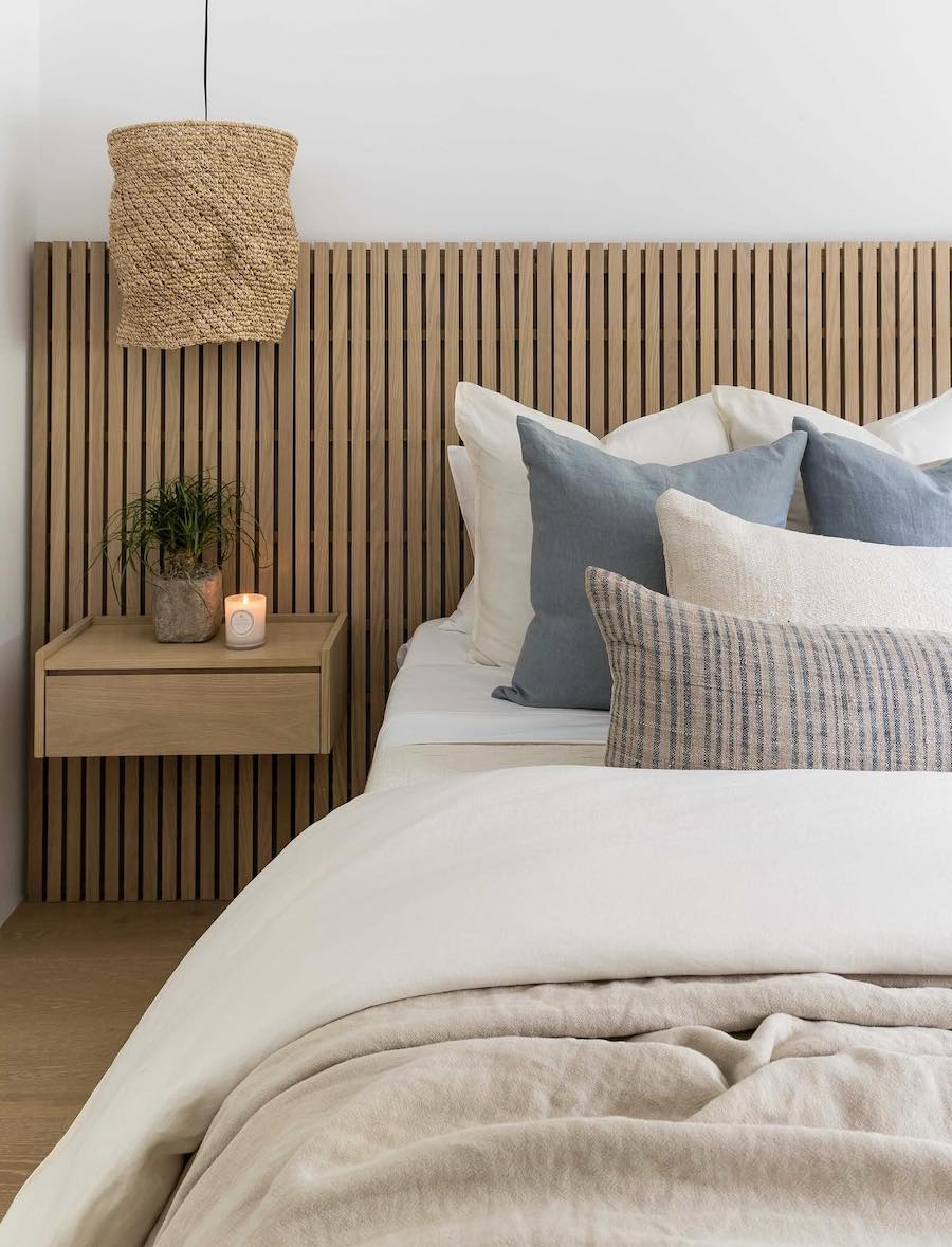 a coastal bedroom with ivory, beige, and blue tones