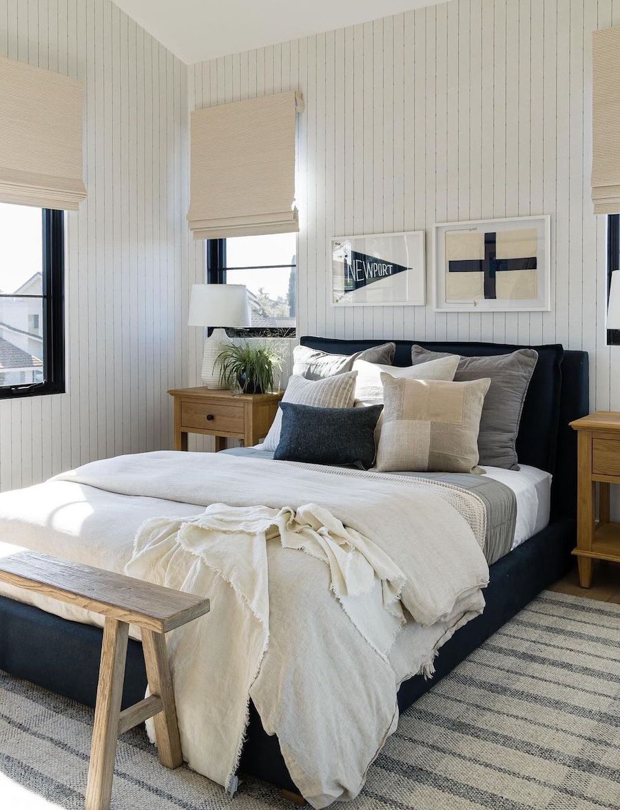 a coastal bedroom with navy and ivory