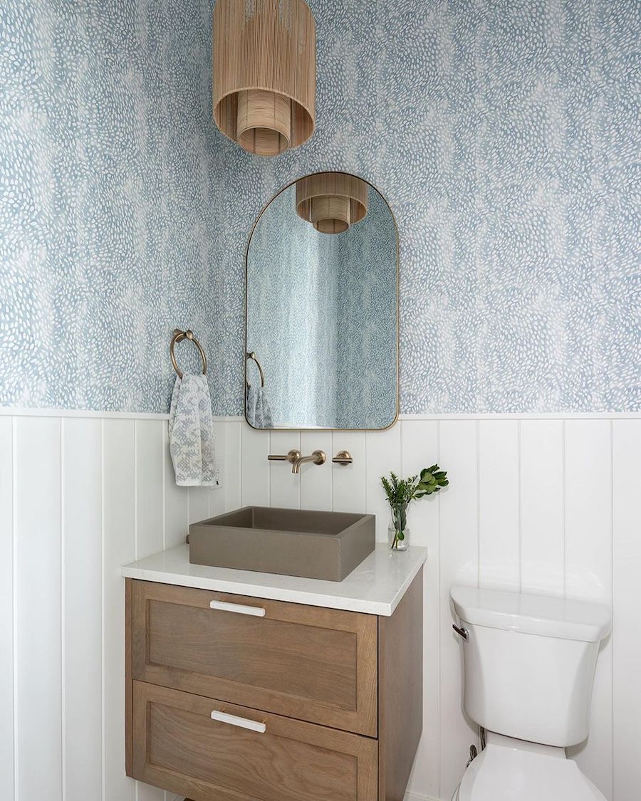 a white, walnut, and blue bathroom with coastal decor