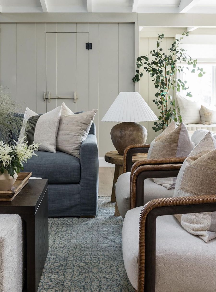 a coastal living room with white, beige, and navy decor