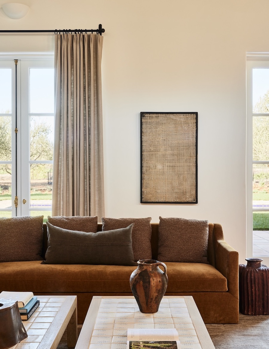 an earthy living room featuring shades of cream and brown and simple, elegant decor