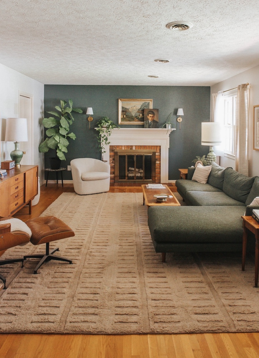 an earthy living room featuring earthy shades of brown, green, and ivory with vintage furnishings