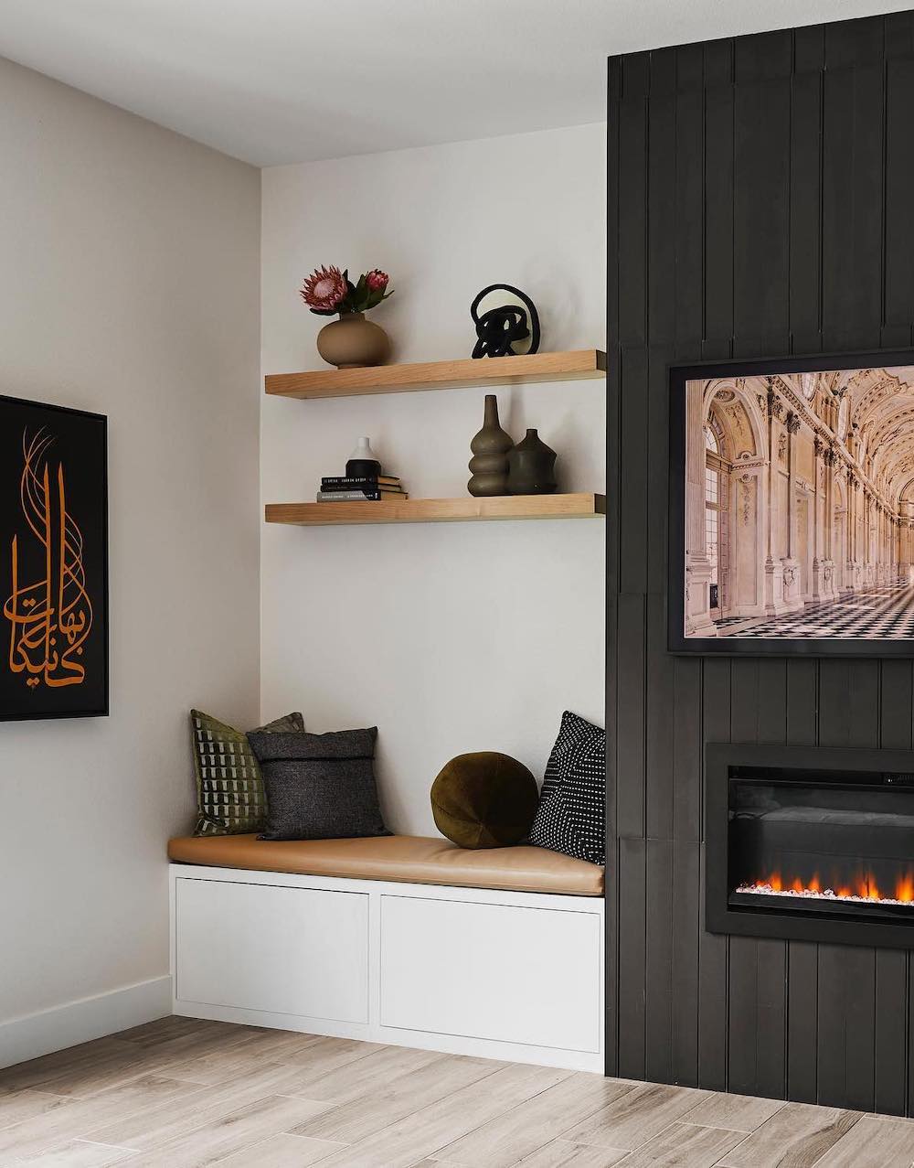a modern neutral room featuring built-in shelves next to the fireplace