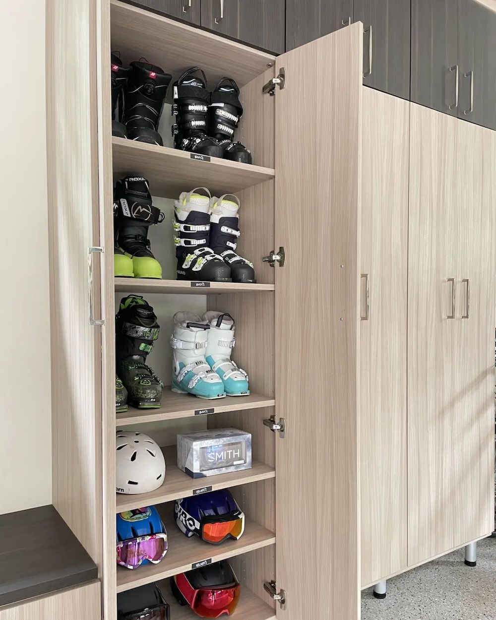 an organized garage featuring tall cabinets