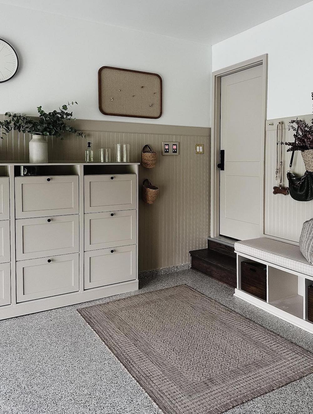 an organized garage featuring an entryway and built in storage