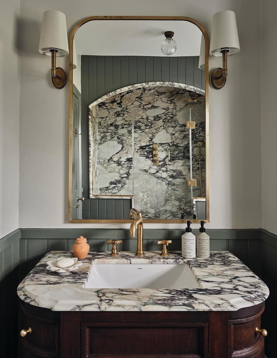 a moody bathroom with a marble sink