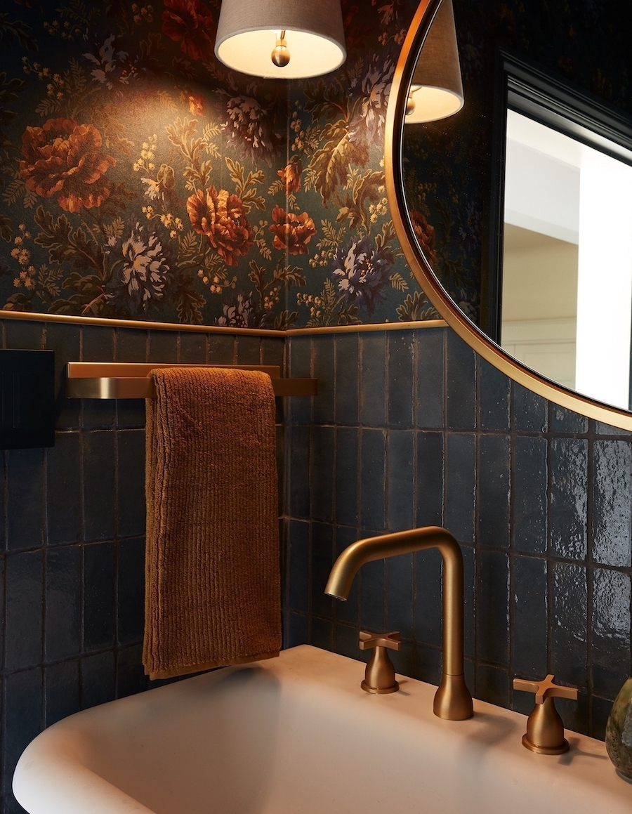 a bathroom with antique decor and moody tones