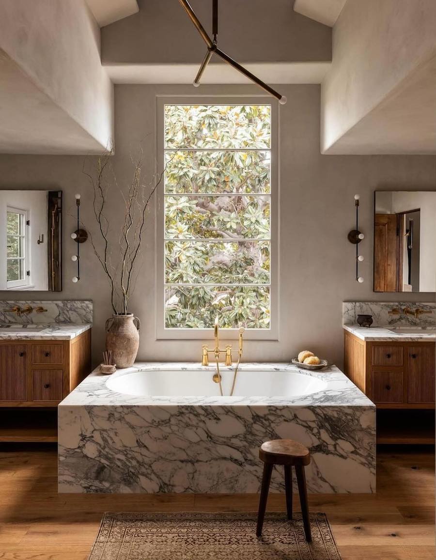 a light toned bathroom with moody decor