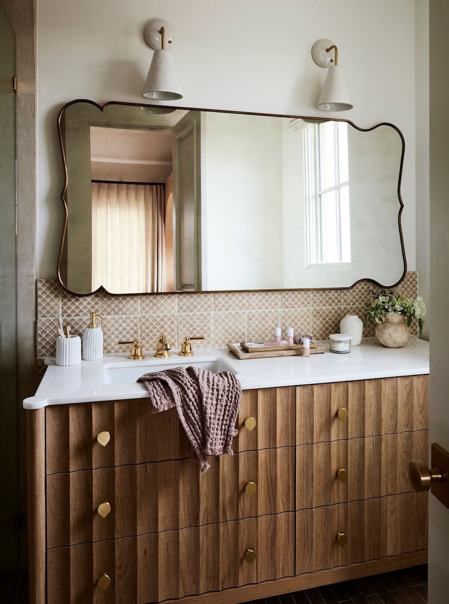 a bathroom with natural materials and moody decor