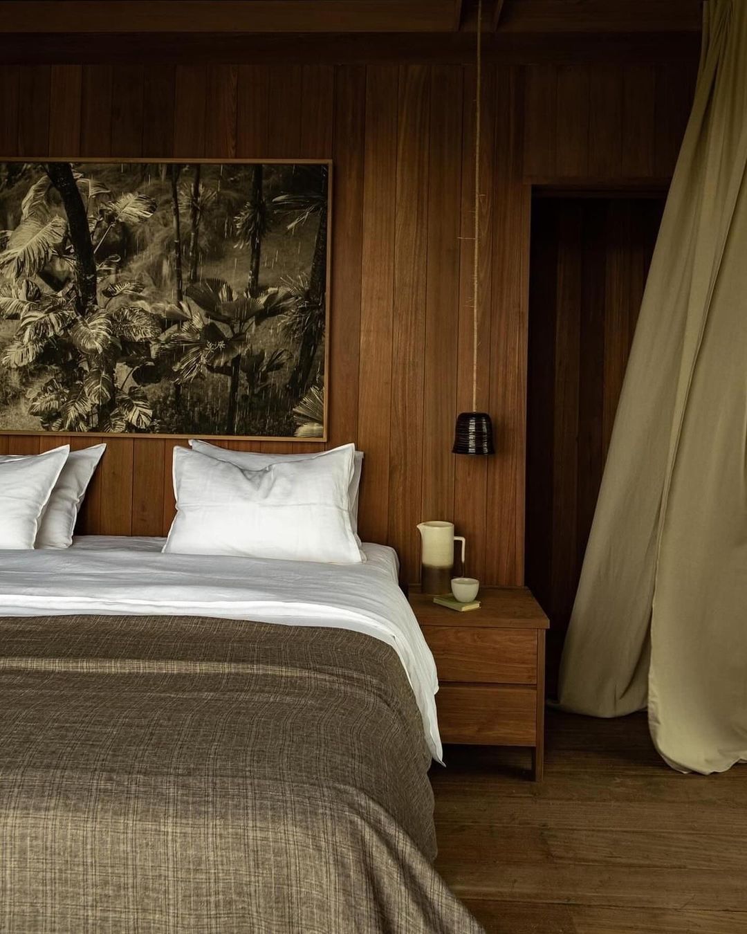 a moody bedroom featuring earthy tones