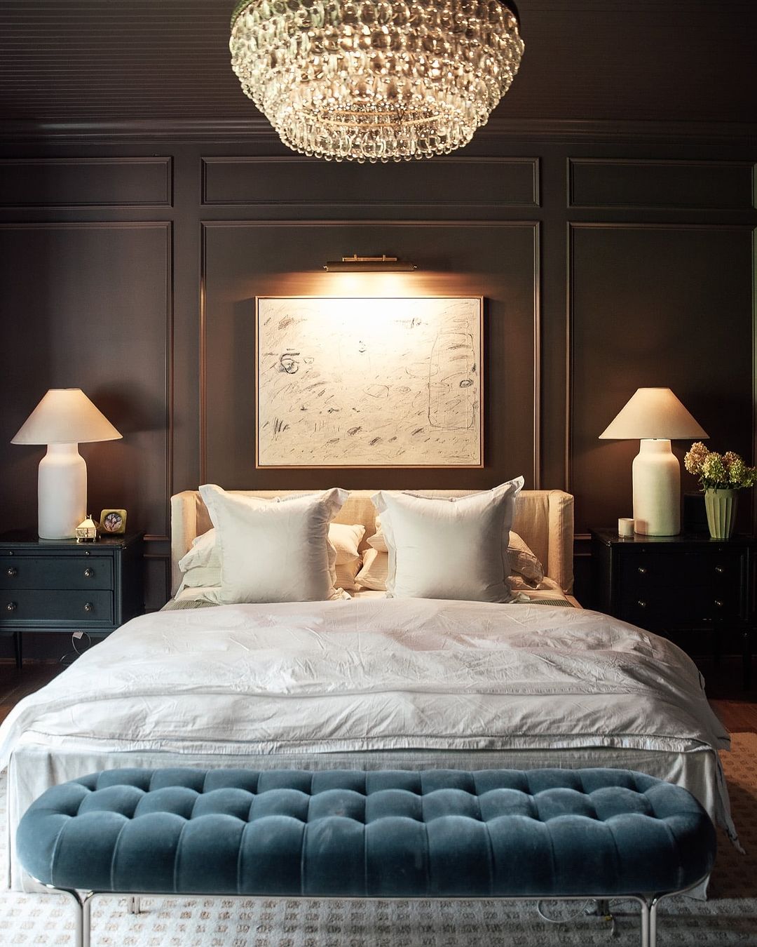 a moody bedroom featuring dramatic and traditional decor