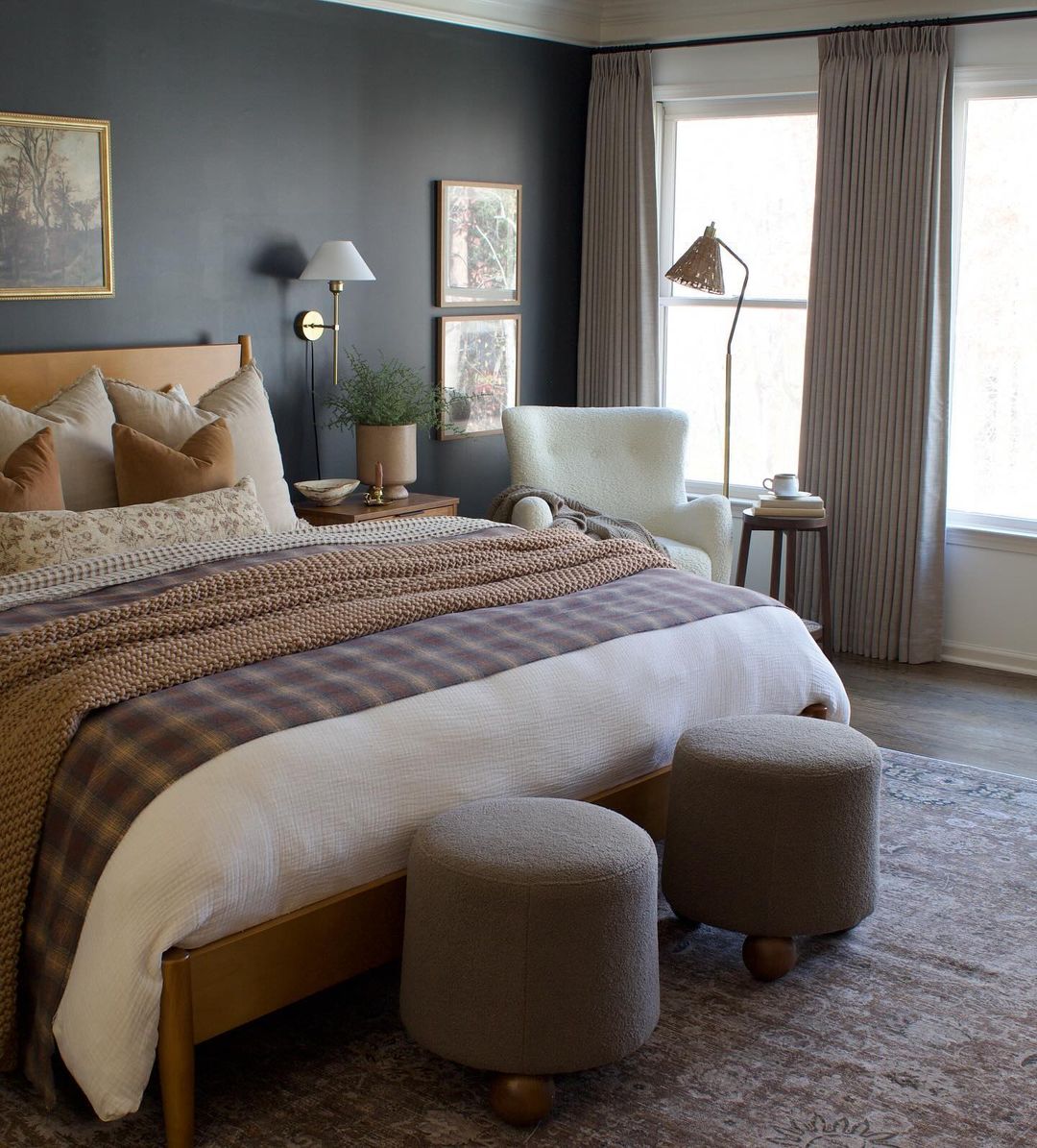 a moody bedroom featuring blue tones and cottage decor