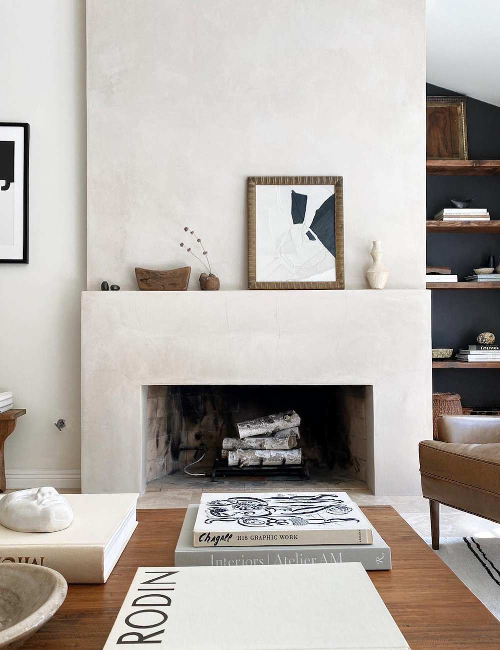 a plaster fireplace with a limewashed hearth