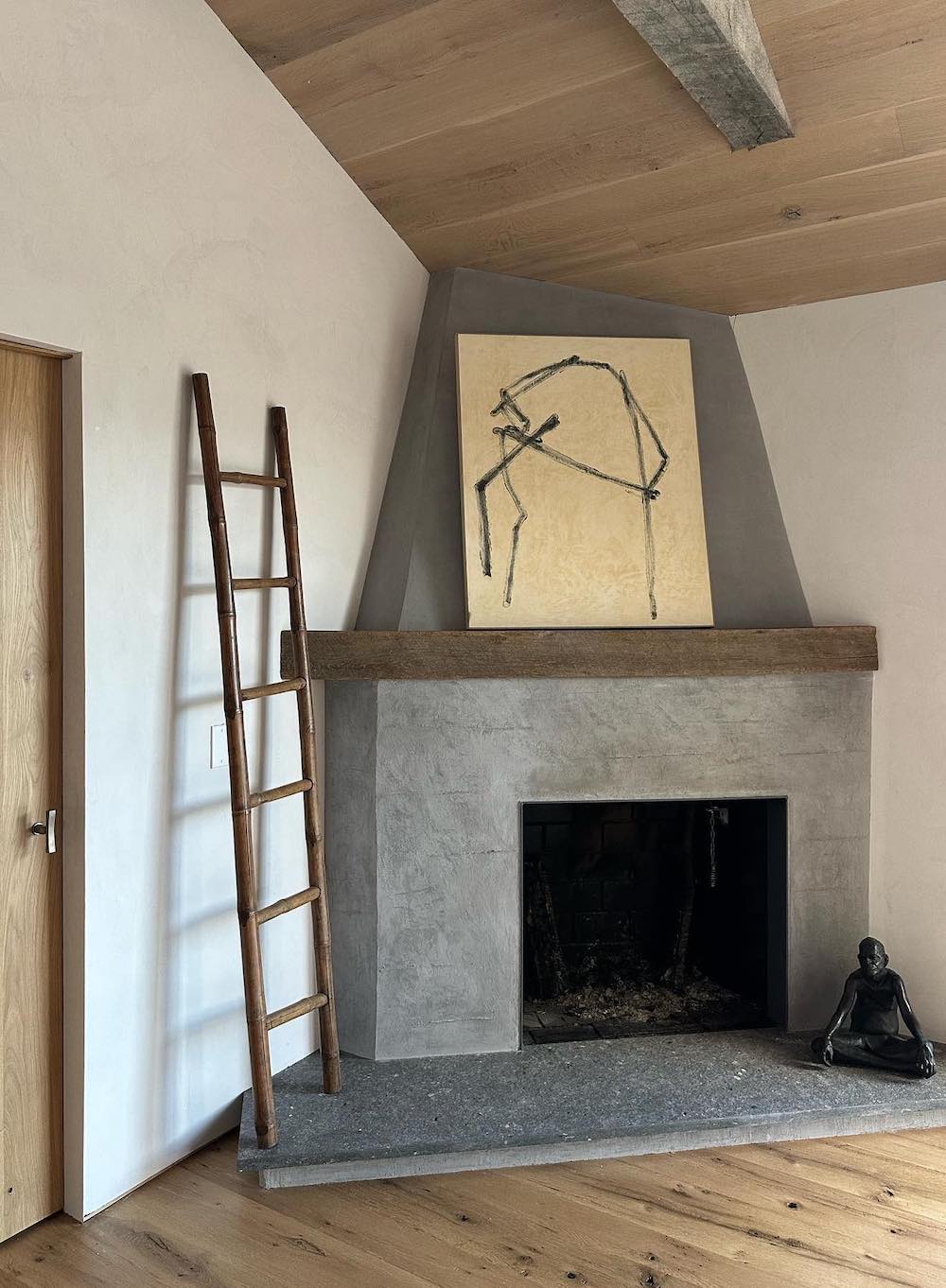 a grey plaster fireplace with minimalist decor