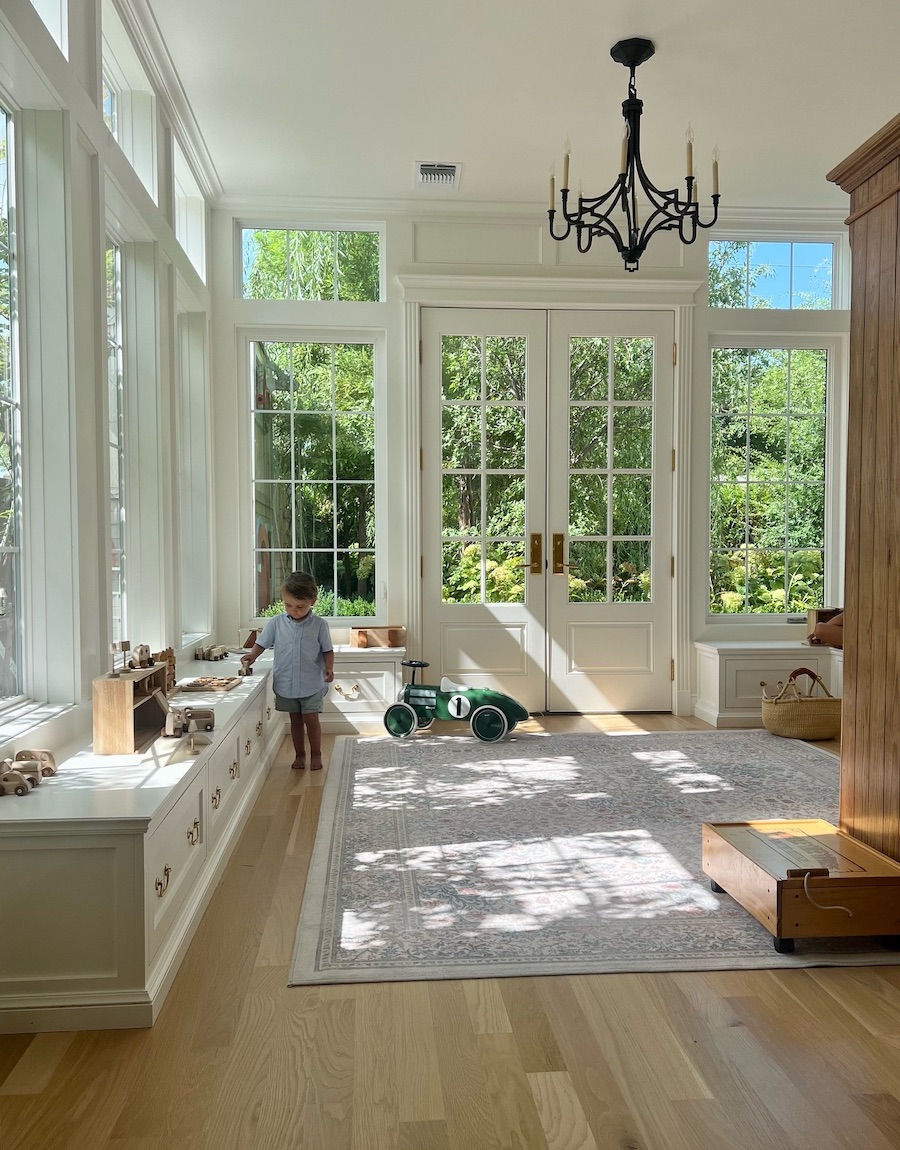 a playroom featuring low drawers and open play space
