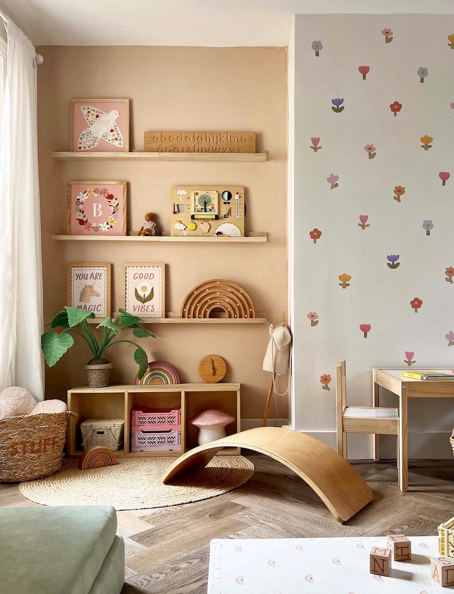 a playroom featuring floral wallpaper and open shelves