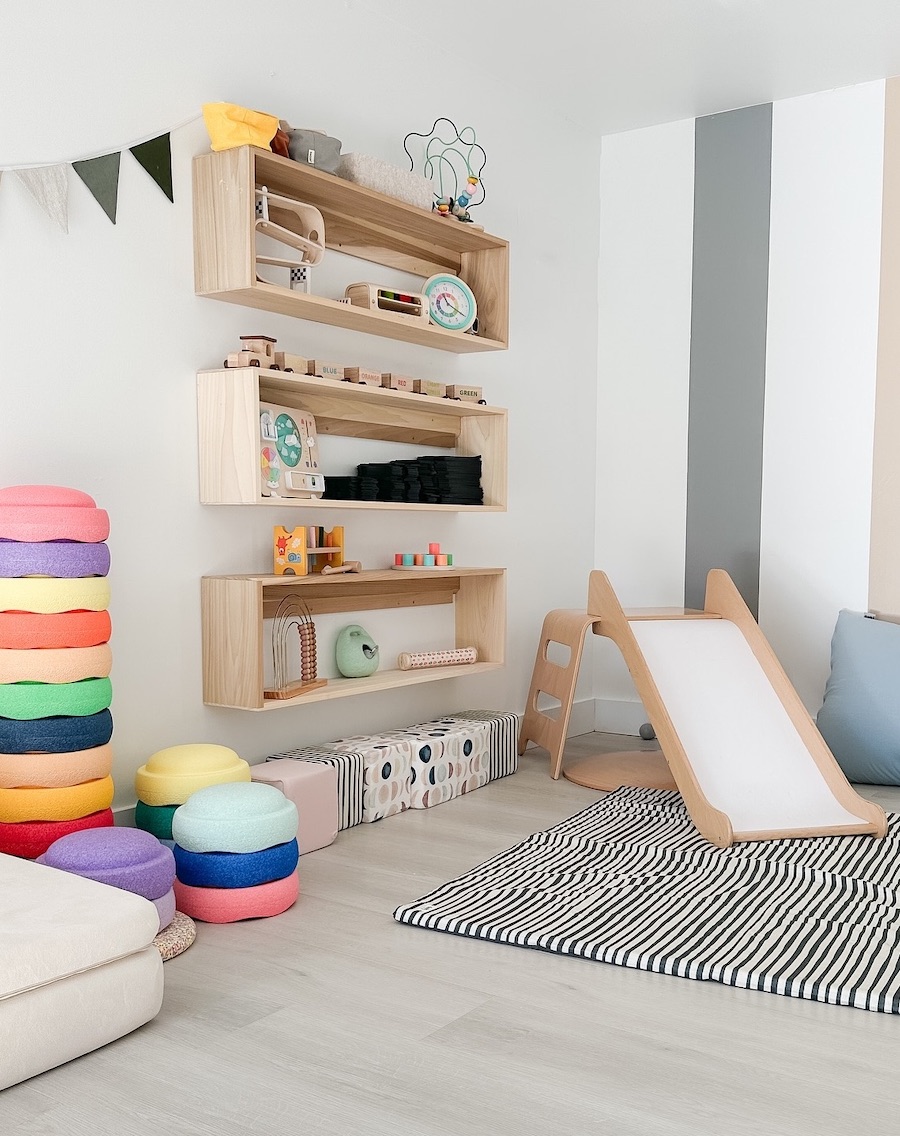 a playroom featuring open shelving and colorful decor