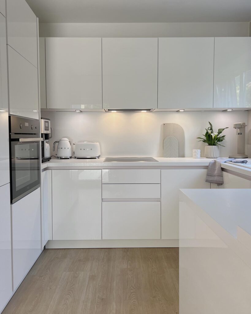 simple white kitchen with down lighting