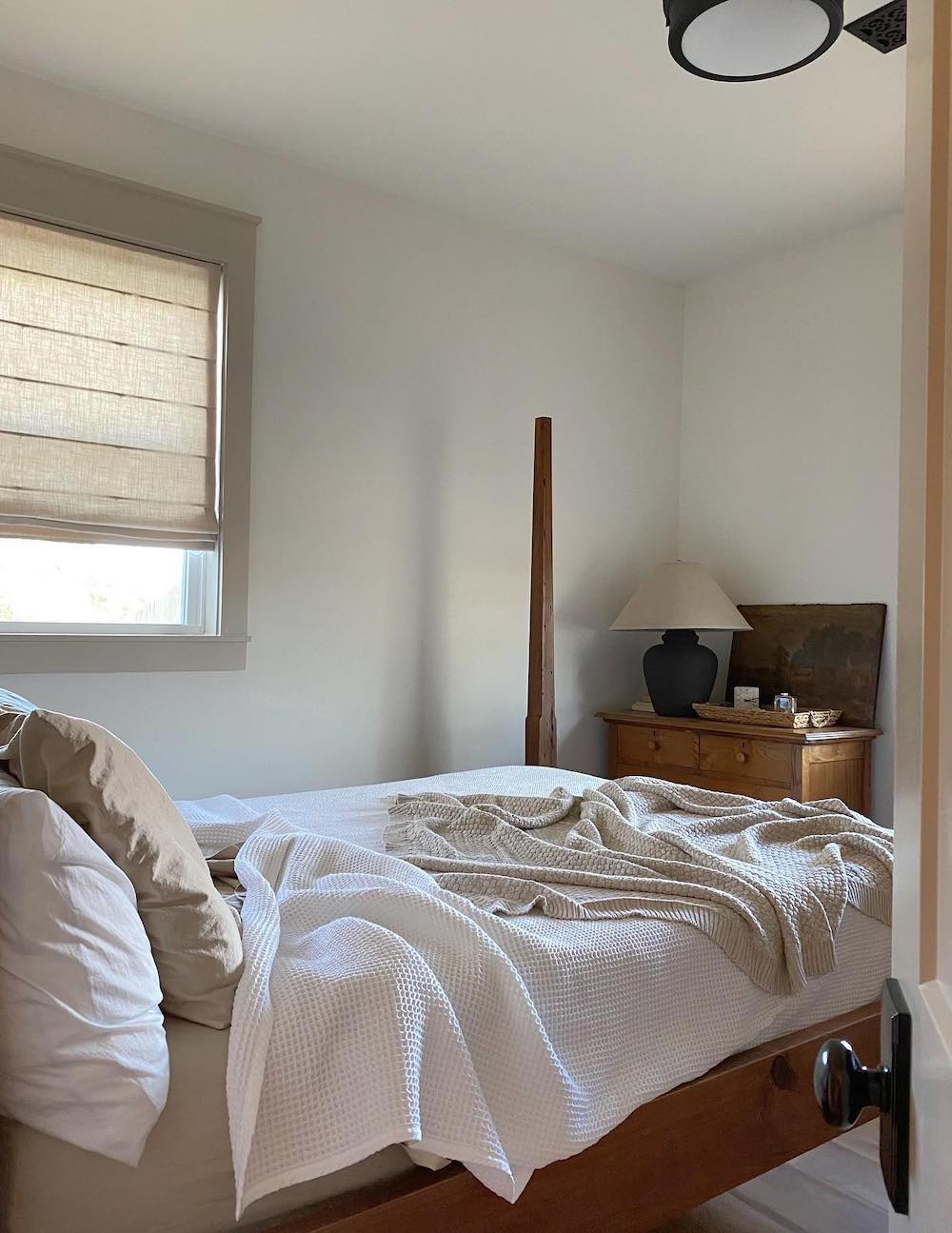 a bedroom with a classic bed frame and waffle knit white bedding