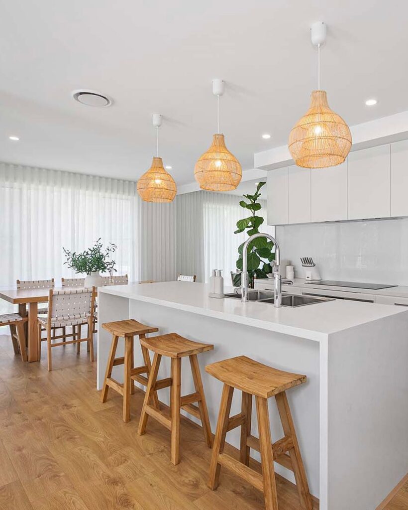 white cabinets with wooden bar stools