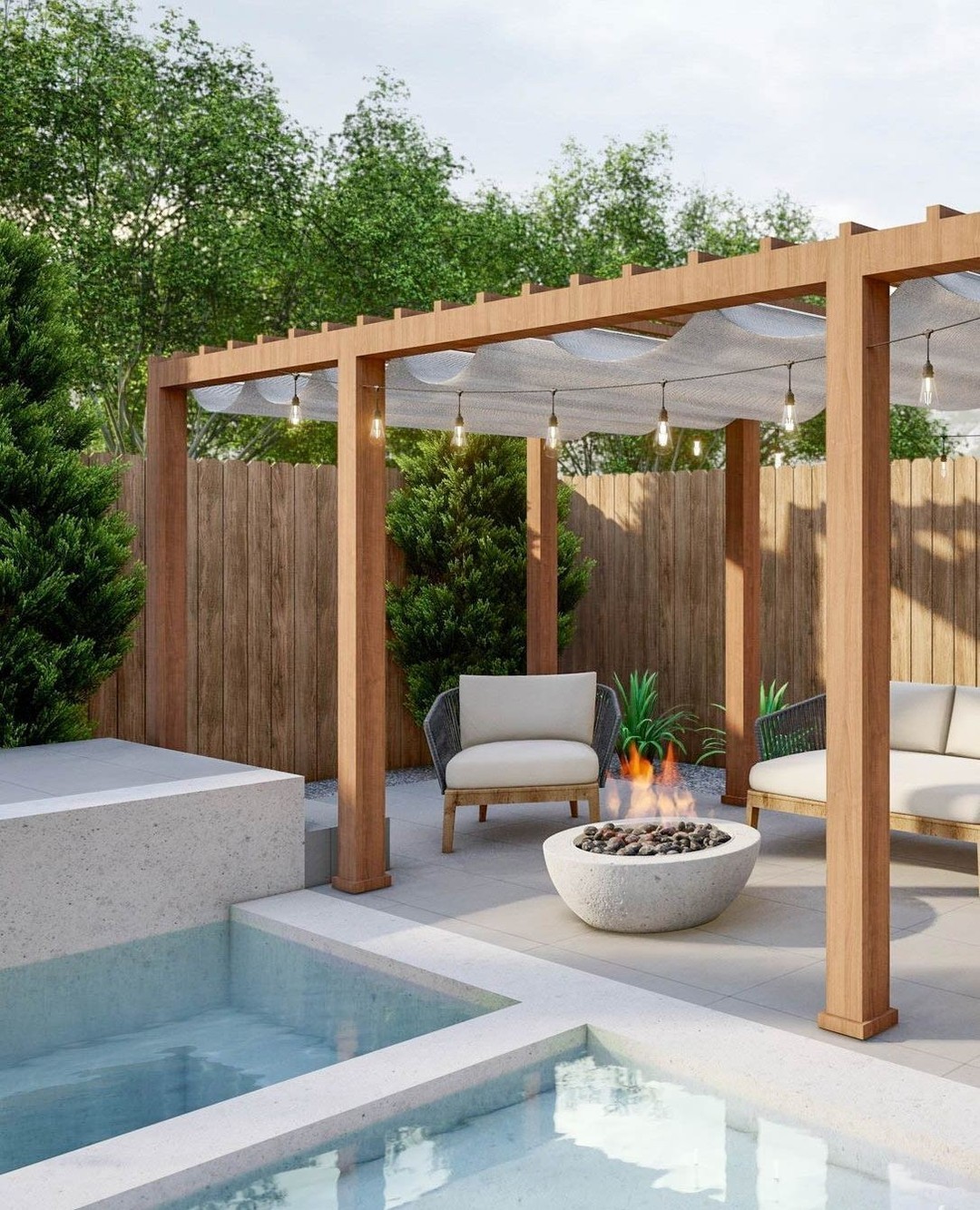 Modern outdoor patio with a wooden pergola—perfect for backyard relaxation—features two chairs, a fire pit, and a small pool, all surrounded by lush greenery and a wooden fence. Explore inspiring pergola ideas for your own outdoor destination.