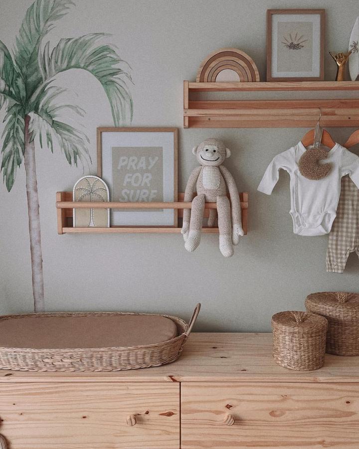 Natural wood shelving displaying coastal ikea baby room hacks & ideas from @mydarlinghart. Sage walls with earthy decor.