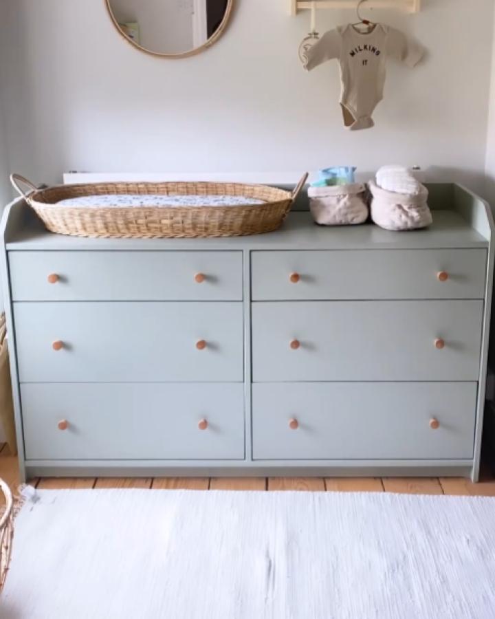 Sage green Hauga dresser from @littlebluenestbaby. Leather knobs and woven changing basket on top.